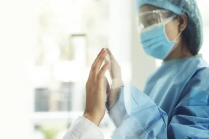 On March 11, 2020, the World Health Organization declared the COVID-19 pandemic. In the photo: a doctor touches the hand of a sick loved one through a glass partition.