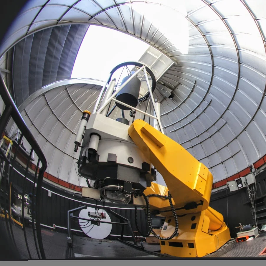 Inside the dome of the Warsaw University Telescope. The large orange-and-yellow structure is the mount used to control the telescope and track the sky. Photo: Ewa Zegler-Poleska