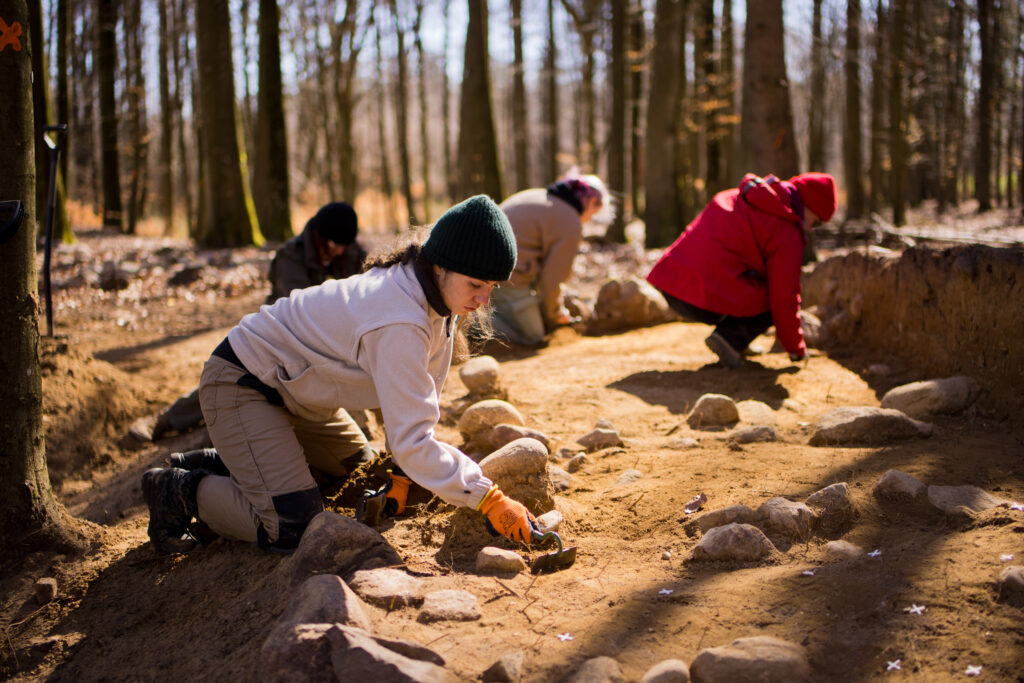 Students exploring the burial mound. 