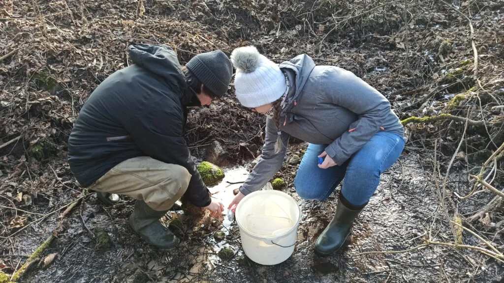 Winter water sampling at a spring in the Jeziorka Valley.
