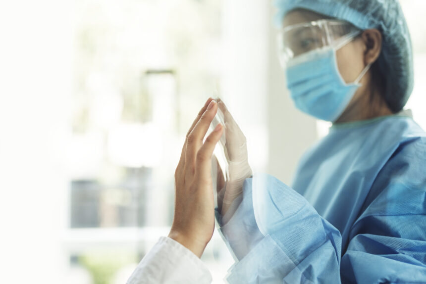 coronavirus-doctor-touching-family-hand-through-glass-window